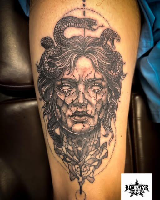 Illustrative blackwork Medusa tattoo on a thigh