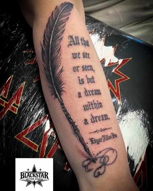 Forearm tattoo of a quill feather beside an Edgar Allan Poe verse in blackletter script